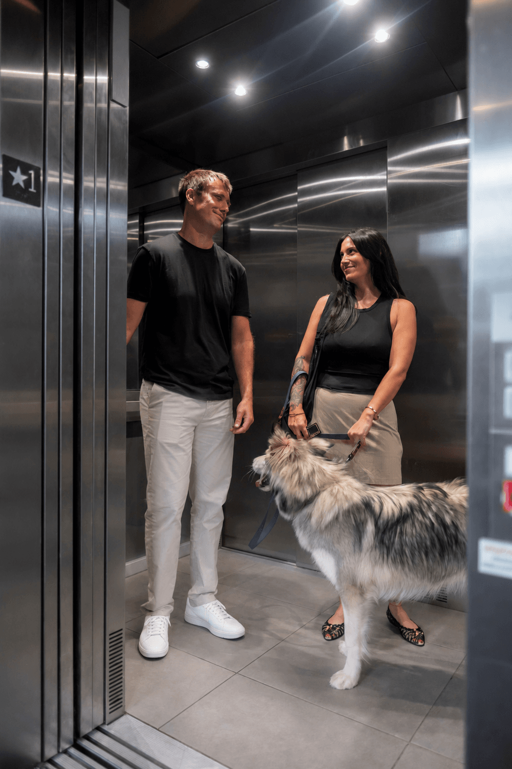 Residents and a dog in a British Square elevator